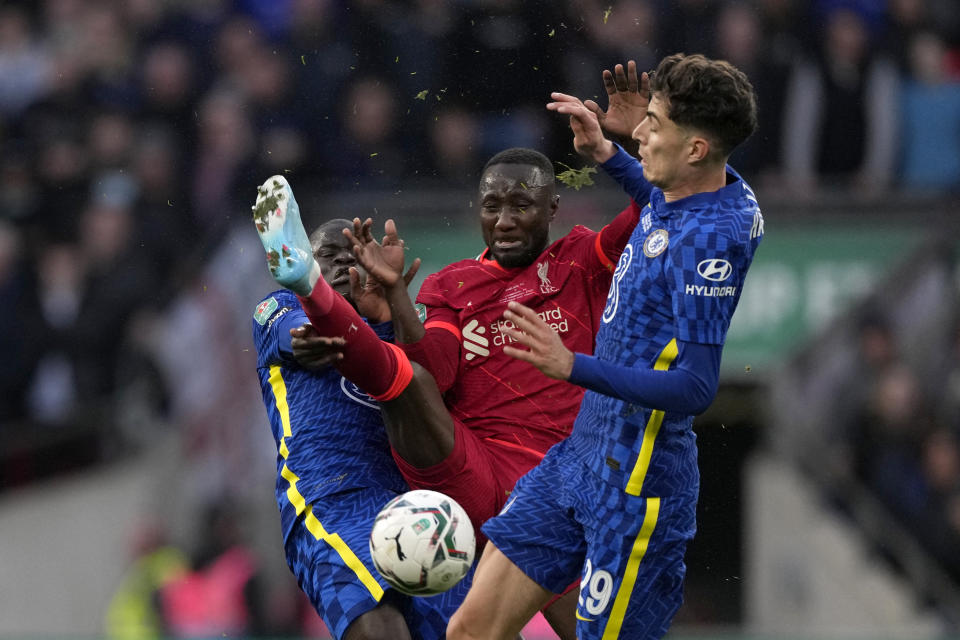 Liverpool's Naby Keita fights for the ball with Chelsea's N'Golo Kante, left, and Kai Havertz, right, during the English League Cup final soccer match between Chelsea and Liverpool at Wembley stadium in London, Sunday, Feb. 27, 2022. (AP Photo/Alastair Grant)