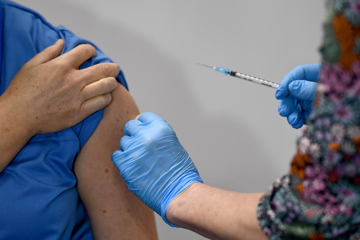 Paula McMahon receives the first of two Pfizer/BioNTech Covid-19 vaccine jabs, administered by Karin Forrest, at the NHS Louisa Jordan Hospital in Glasgow, on the first day of the largest immunisation programme in the UK's history. Care home workers, NHS staff and people aged 80 and over began receiving the jab this morning.