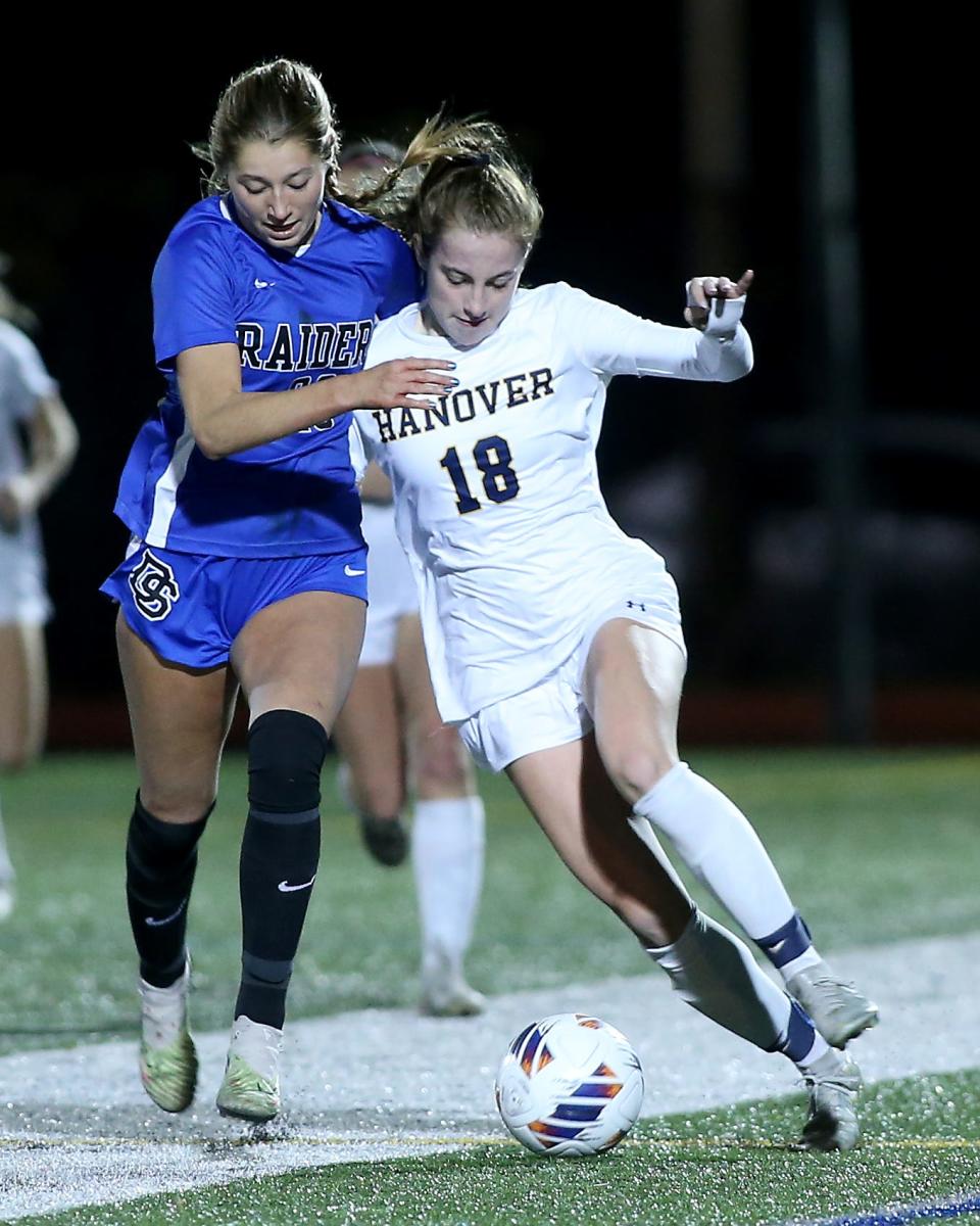 Dover-Sherborn's Hayden Sumner, left, and Hanover’s Sophie Schiller battle for the ball during the first overtime period in the Division 3 girls soccer state semifinal game at Manning Field in Lynn on Wednesday, November 15, 2023. Hanover would go on to win 2-1 in double-overtime.