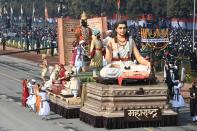 Performers dance next to a float representing Maharashtra state on Rajpath during the Republic Day parade in New Delhi on January 26, 2021. (Photo by Jewel SAMAD / AFP) (Photo by JEWEL SAMAD/AFP via Getty Images)