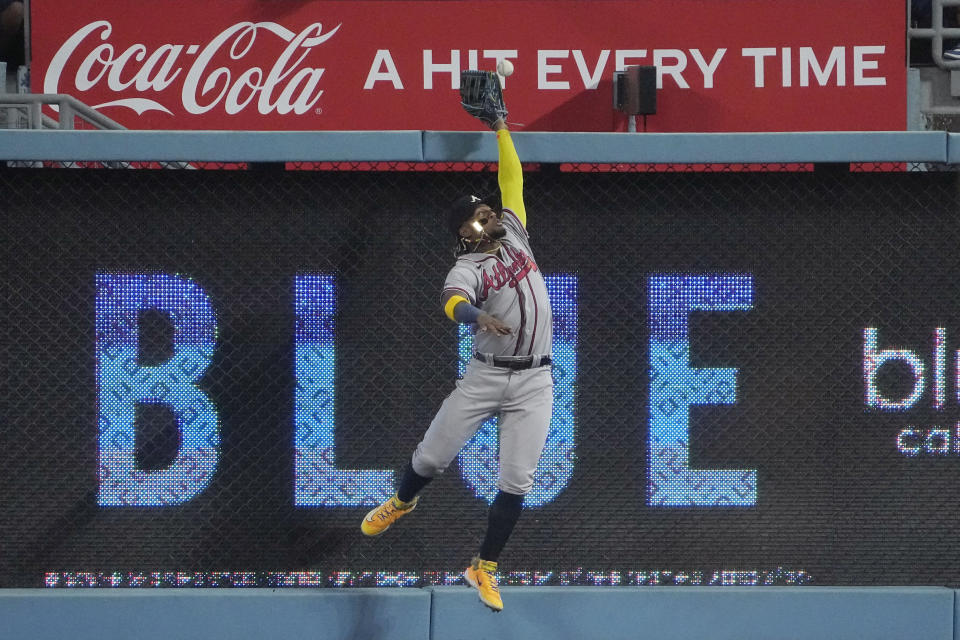 Atlanta Braves right fielder Ronald Acuna Jr. can't catch a ball hit for a three-run home run by Los Angeles Dodgers' Mookie Betts during the fifth inning of a baseball game Thursday, Aug. 31, 2023, in Los Angeles. (AP Photo/Mark J. Terrill)