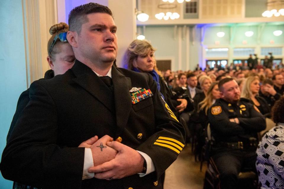 Members of law enforcement watch the funeral for Bay St. Louis police officers Sgt. Steven Robin and Branden Estorffe at the Bay St. Louis Community Center in Bay St. Louis on Wednesday, Dec. 21, 2022.