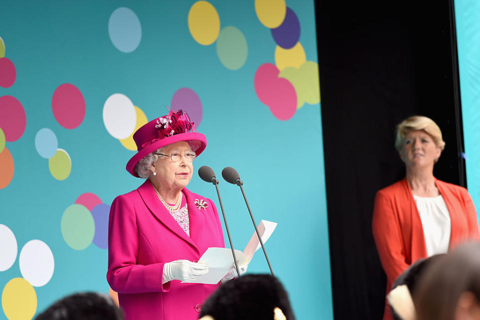 Queen Elizabeth II and Clare Balding are seen on stage during 