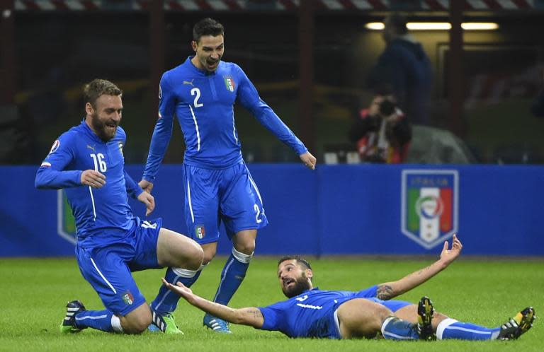 Italy's Antonio Candreva (R) celebrates with teammates Mattia De Sciglio (C) and Daniele de Rossi, after scoring a goal during their 2016 Euro qualifying match against Croatia, at the San Siro stadium in Milan, on November 16, 2014