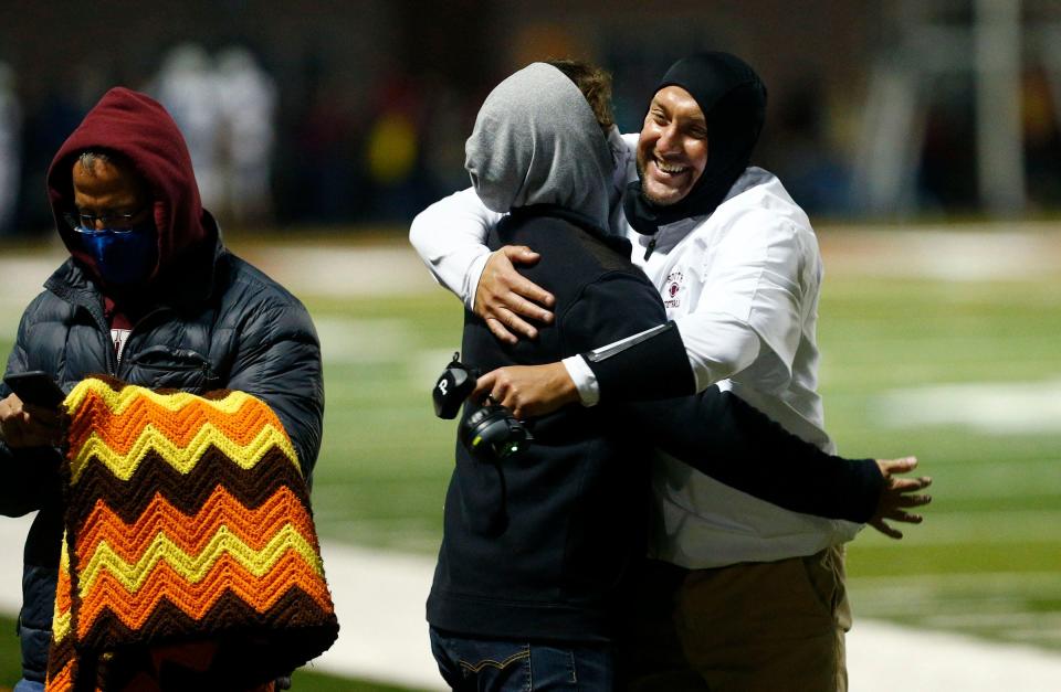 Toms River South defensive coodinator Matt Martin gets a hug after his team defeated north at home Friday night, October 2, 2020.