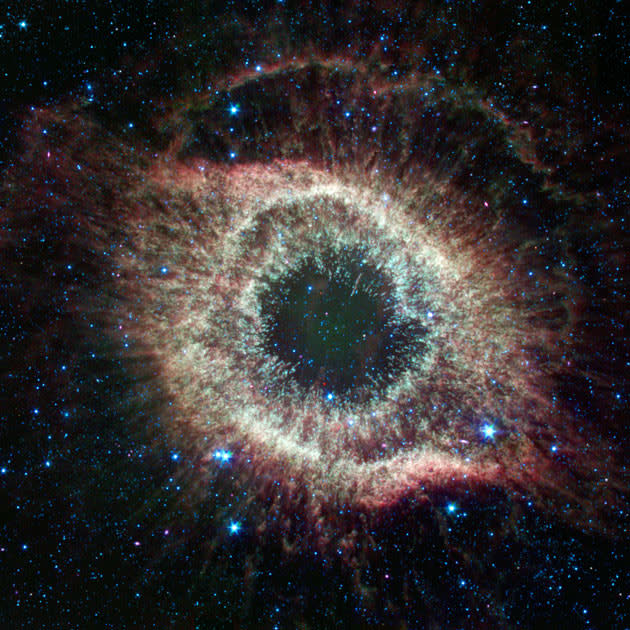 This NASA handout image received 28 August 2007 shows a newly expanded image of the Helix nebula on the the fourth anniversary of the launch of NASA's Spitzer Space Telescope. This spectacular object, a dying star unraveling into space, is a favorite of amateur and professional astronomers alike. Spitzer has mapped the expansive outer structure of the six-light-year-wide nebula, and probed the inner region around the central dead star to reveal what appears to be a planetary system that survived the star's chaotic death throes. The minimum expected lifetime of Spitzer was only two-and-one-half years. Now, Spitzer's cryogen is expected to last much longer, giving the mission a lifetime of more than five-and-one-half years. AFP PHOTO/NASA/JPL-CALTECH/HO