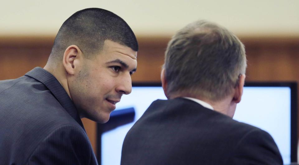 Former New England Patriots NFL football player Aaron Hernandez (L) talks with his lawyer Charles Rankin during his murder trial at Bristol County Superior Court in Fall River, Massachusetts February 26, 2015. Hernandez is charged in the murder of Odin Lloyd in 2013. REUTERS/Charles Krupa/Pool (UNITED STATES - Tags: SPORT FOOTBALL CRIME LAW)