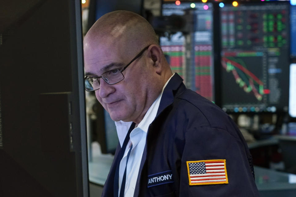 Trader Anthony Confusione works on the floor of the New York Stock Exchange, Wednesday, Dec. 1, 2021. Wall Street has investors on another roller-coaster ride Wednesday, as an early stock market rally lost steam in afternoon trading. (AP Photo/Richard Drew)