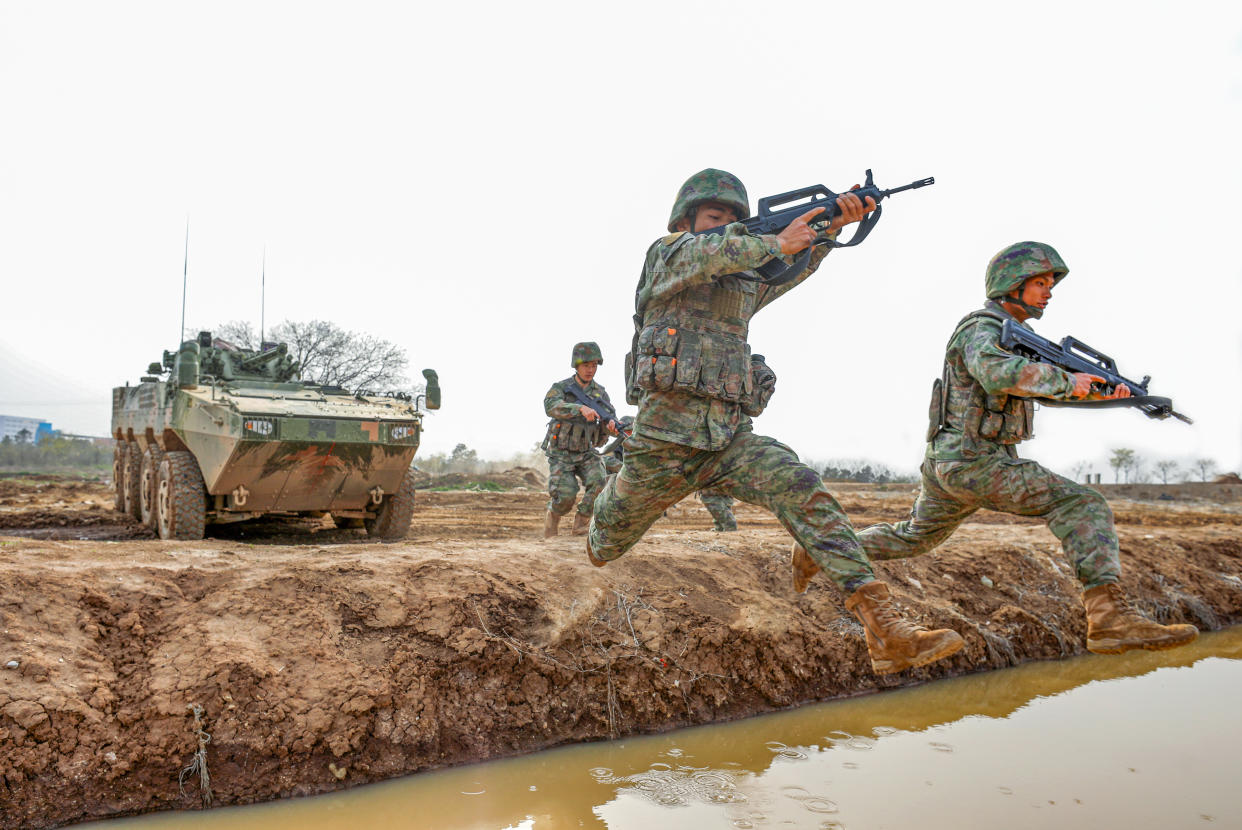 HUAIBEI, CHINA - APRIL 23, 2023 - Infantry soldiers cross water trenches in Huaibei city, Anhui province, China, April 23, 2023. A live firing drill of a brigade of the 72nd Group Army started at a field training ground. (Photo credit should read CFOTO/Future Publishing via Getty Images)