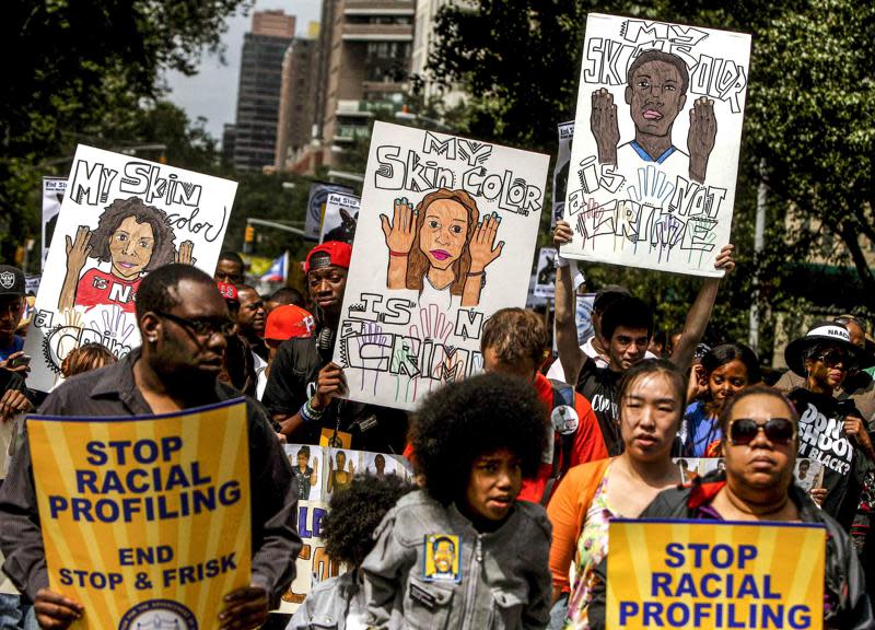 This photo from Sunday, June 17, 2012, shows protestors with signs during a silent march to end “stop-and-frisk” program in New York. (AP Photo/Seth Wenig, File)