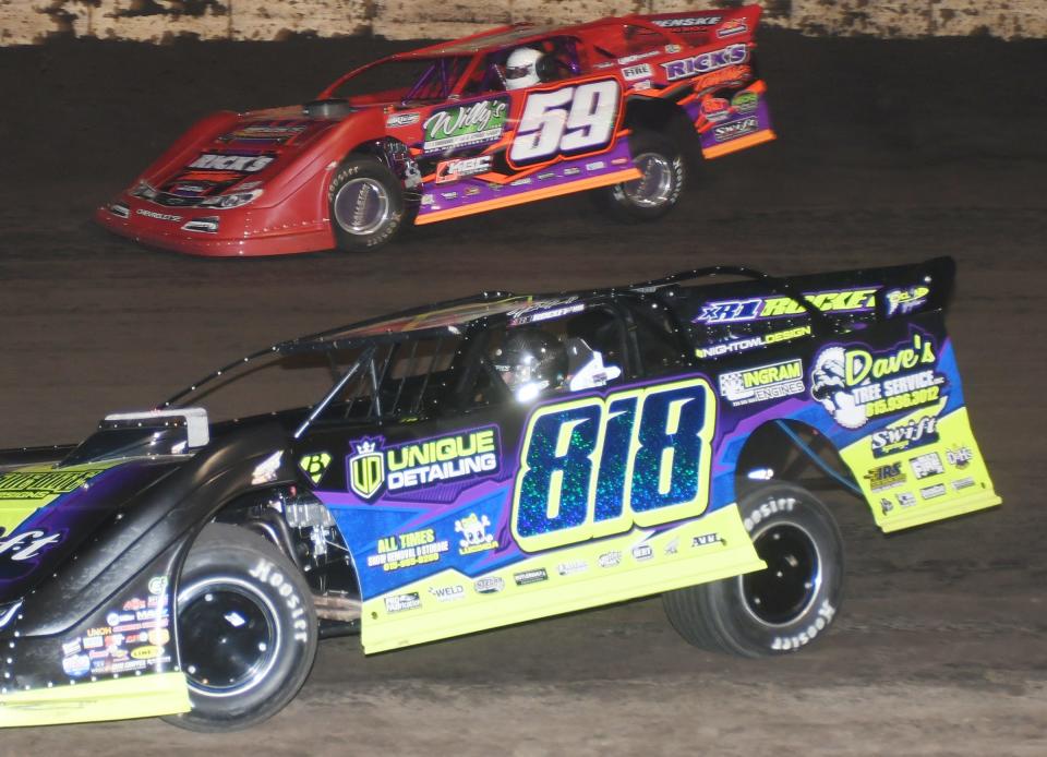 Matt Hammond (818) races with Aaron Heck at a recent race at Fairbury. Hammond has made the jump from motocross to stock car to pro late model racing in his young career.