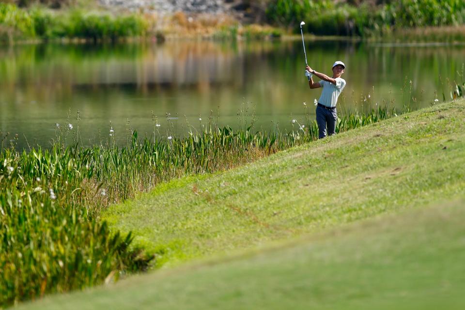 Miles Russell hits a shot from off the first fairway at the Lakewood National Commander Course in Lakewood Ranch. He double-bogeyed the hole but rallied later in the round and shot 70.