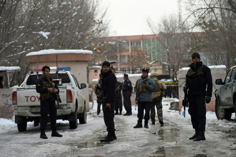 Afghan security personnel stand guard at the site of a suicide blast near the Afghan Supreme Court in Kabul on February 7, 2017