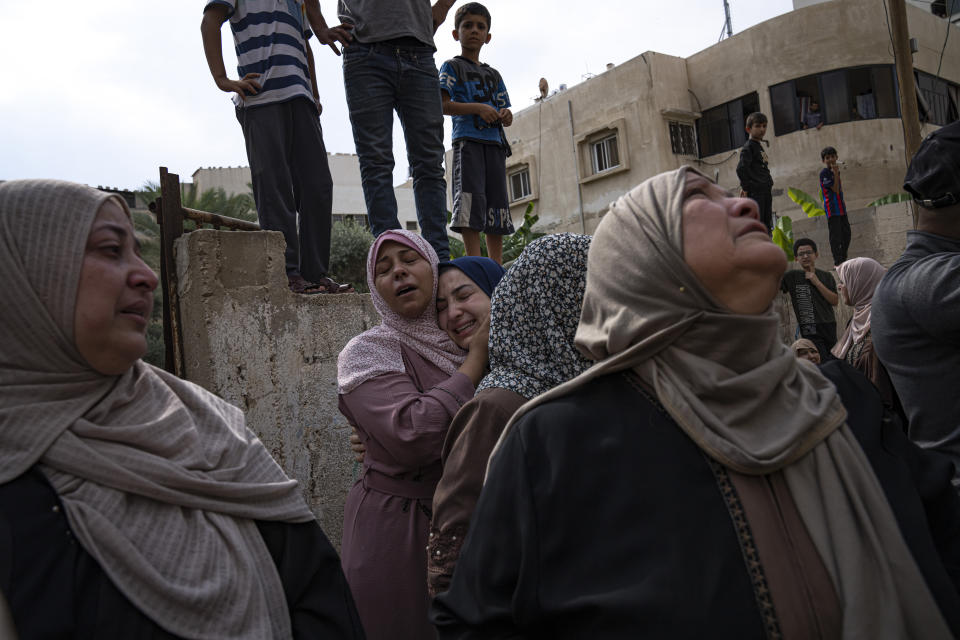 People mourn those killed in an Israeli airstrike in Gaza City on Monday. (Fatima Shbair/AP)