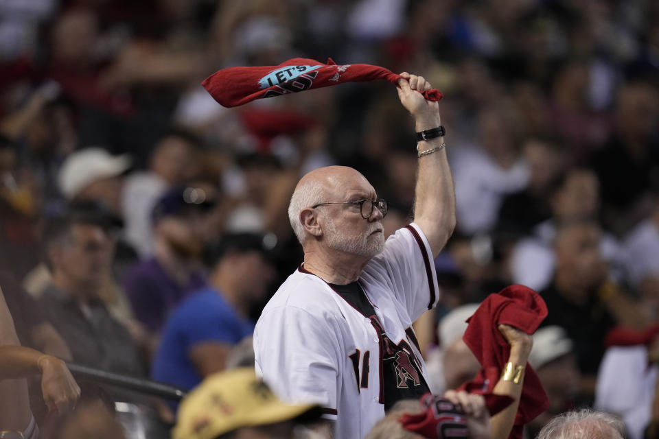 An Arizona Diamondbacks fan looks on during the seventh inning in Game 3 of a baseball NL Division Series against the Los Angeles Dodgers, Wednesday, Oct. 11, 2023, in Phoenix. (AP Photo/Ross D. Franklin)