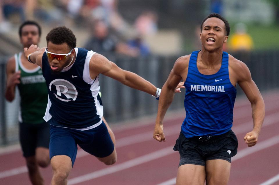 Memorial’s Anthony Brodie, right, crosses the finish line next to Reitz’s Xavier Thomas during the 100 meter dash event of the IHSAA Boys Track and Field sectional 32 at Central High School in Evansville, Ind., Thursday, May 19, 2022. Brodie set a new sectional record of 10.58 seconds while Thomas had a time of 10.63. 