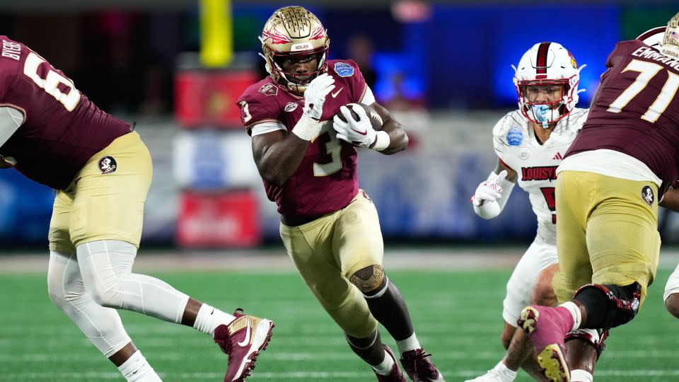 Running back Trey Benson and the Florida State Seminoles were excluded from the college football playoff despite a perfect 13-0 record. - Jim Dedmon/USA Today Sports via Reuters