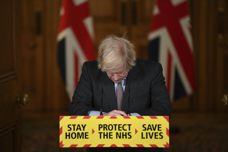 FILE - Prime Minister Boris Johnson reacts while leading a virtual news conference on the COVID-19 pandemic, inside 10 Downing Street in central London on Jan. 26, 2021. The moving vans have already started arriving in Downing Street, as Britain's Conservative Party prepares to evict Johnson. Debate about what mark he will leave on his party, his country and the world will linger long after he departs in September. (Justin Tallis/Pool via AP, File)