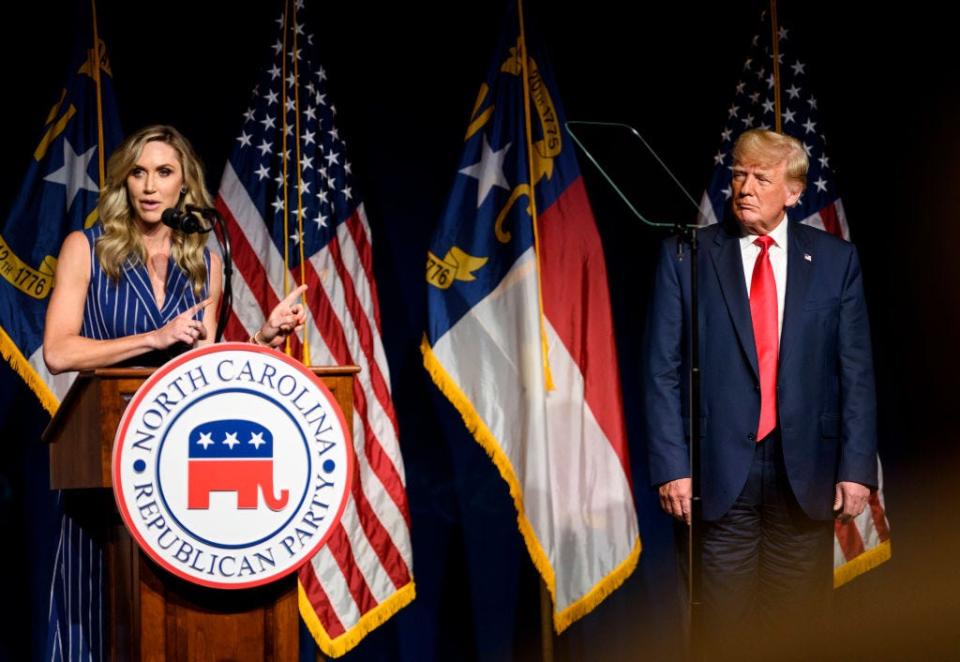 Lara Trump points to Donald Trump at an event for the North Carolina Republican Party