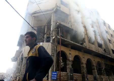 A smoke rises from a building after an airstrike in the besieged town of Douma, Eastern Ghouta, Damascus, Syria February 9, 2018. REUTERS/Bassam Khabieh