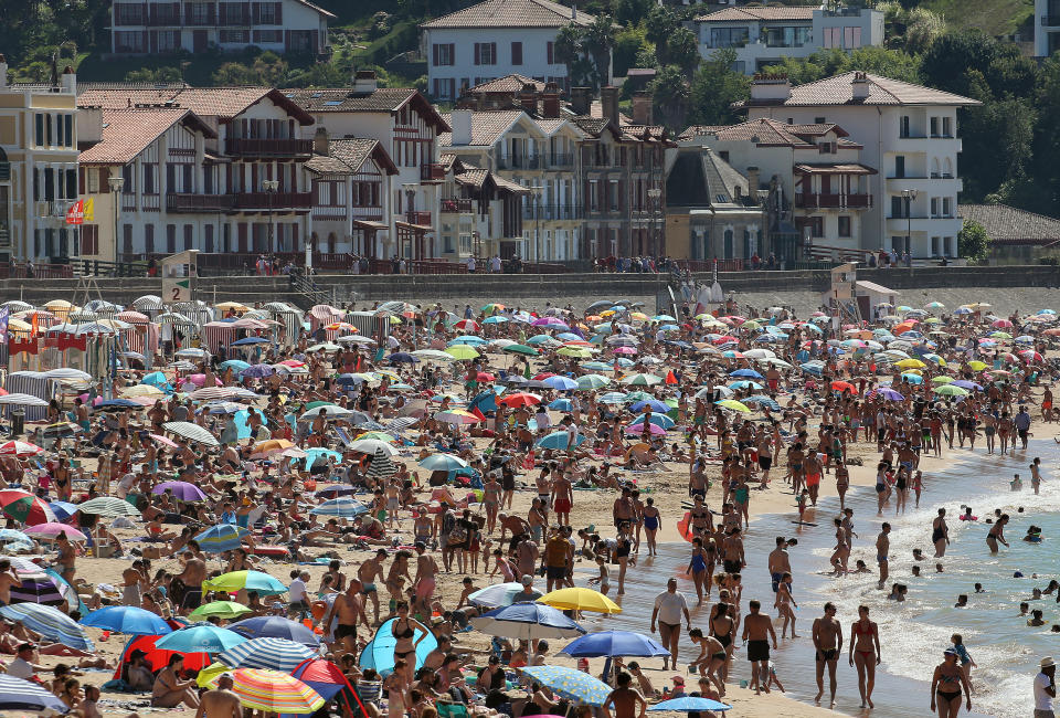 FILE - In this Saturday, July 18, 2020 file photo, people sunbathe in Saint Jean de Luz' beach, southwestern France. France on Friday Oct. 23, 2020 surpassed 1 million confirmed coronavirus cases, becoming the second country in Western Europe after Spain to reach the mark. (AP Photo/Bob Edme, File)