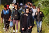 Migrants from Afghanistan walk after they crossed the border from Serbia to Hungary, near the village of Asotthalom, Hungary, on June 29, 2015. REUTERS/Laszlo Balogh