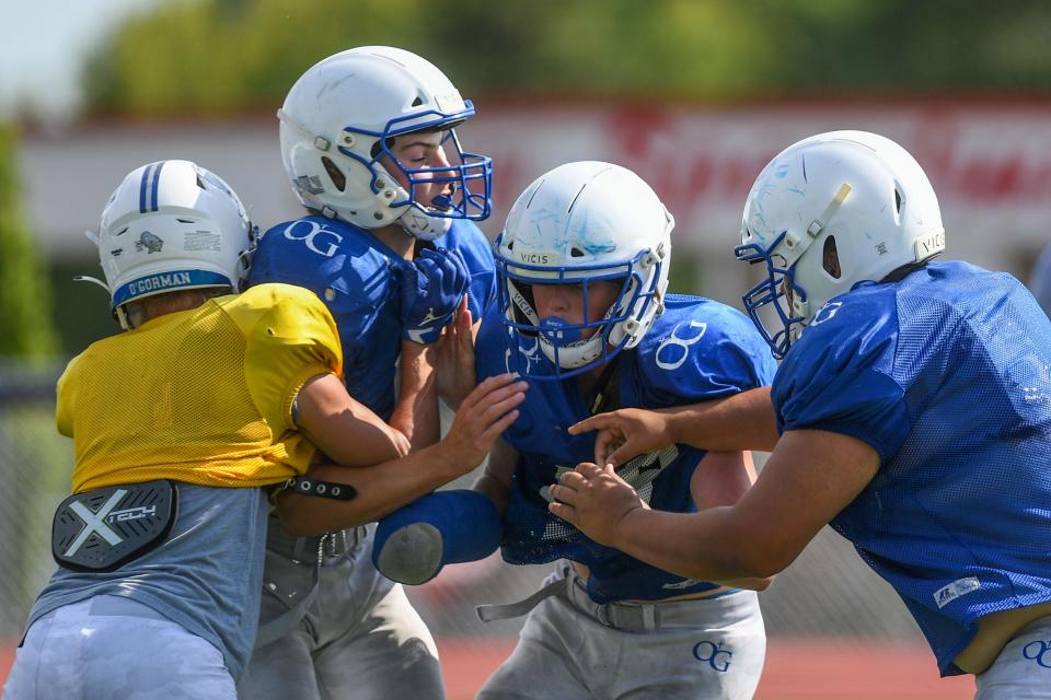 O'Gorman football players tackle each other during practice at O'Gorman High School in Sioux Falls, South Dakota on Wednesday, August 16, 2023.