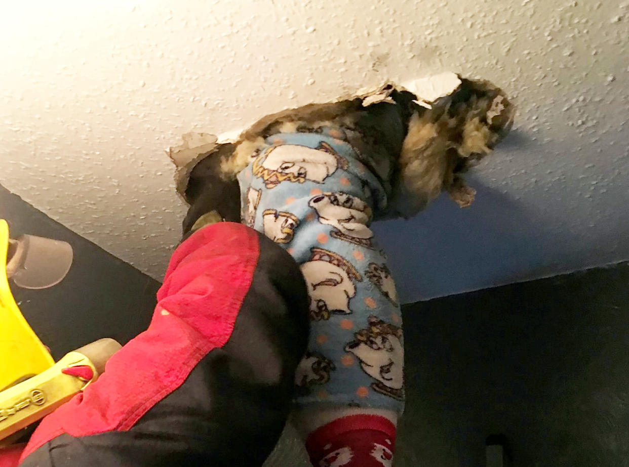 <em>Claus-trophobic – Stacielea Doran had to be rescued by firefighters after falling through her ceiling – in her Beauty and the Beat onesie (Picture: SWNS)</em>