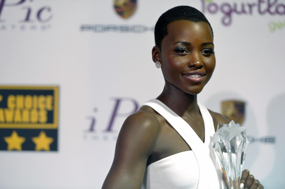 Lupita Nyong'o poses with the award for best supporting actress for "12 Years a Slave" in the press room at the 19th annual Critics' Choice Movie Awards at the Barker Hangar on Thursday, Jan. 16, 2014, in Santa Monica, Calif. (Photo by John Shearer/Invision/AP)