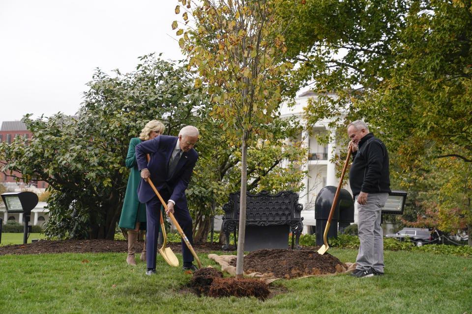 President Joe Biden, first lady Jill Biden and Dale Haney, the chief White House groundskeeper, right, participate in a tree planting ceremony on the South Lawn of the White House, Monday, Oct. 24, 2022, in Washington. As of this month, Haney has tended the lawns and gardens of the White House for 50 years. (AP Photo/Evan Vucci)