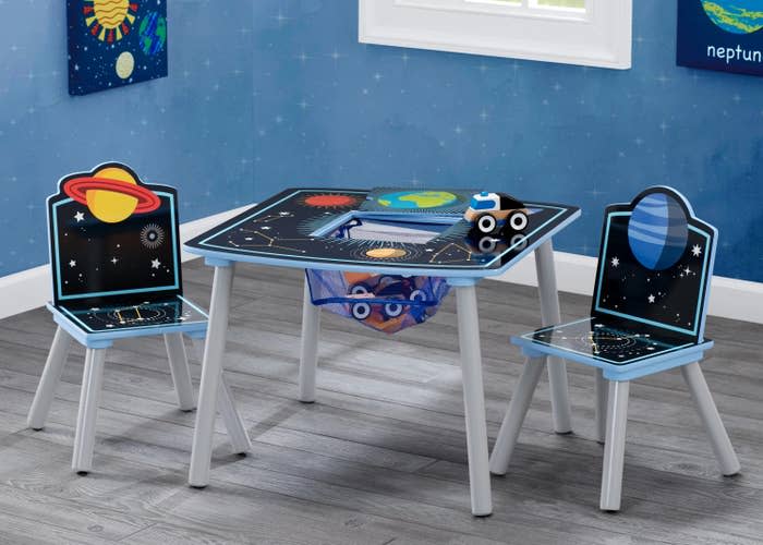 The table with two chairs, featuring planetary designs