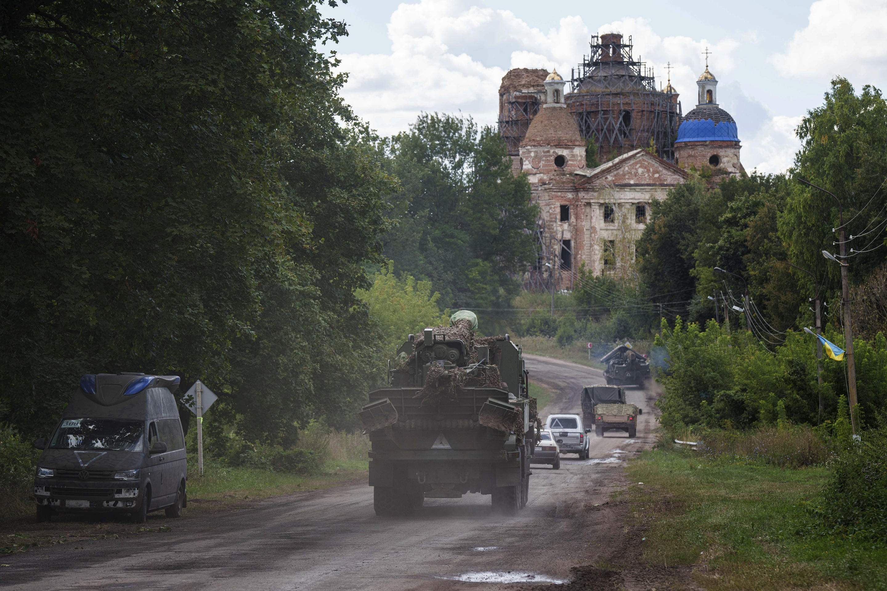 Military vehicles drive near the Russian-Ukrainian border in the Sumy region. 