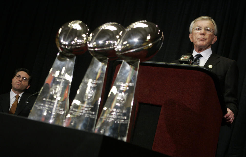 FILE - Washington Redskins coach and team president Joe Gibbs, right, announces his resignation from the NFL football team as Redskins owner Dan Snyder, left, listens, Tuesday, Jan. 8, 2008, in Ashburn, Va. Few NFL teams have managed to lose as much as Washington has since Daniel Snyder was part of a group that purchased the franchise for a then-record $800 million in 1999. (AP Photo/Haraz N. Ghanbari, File)