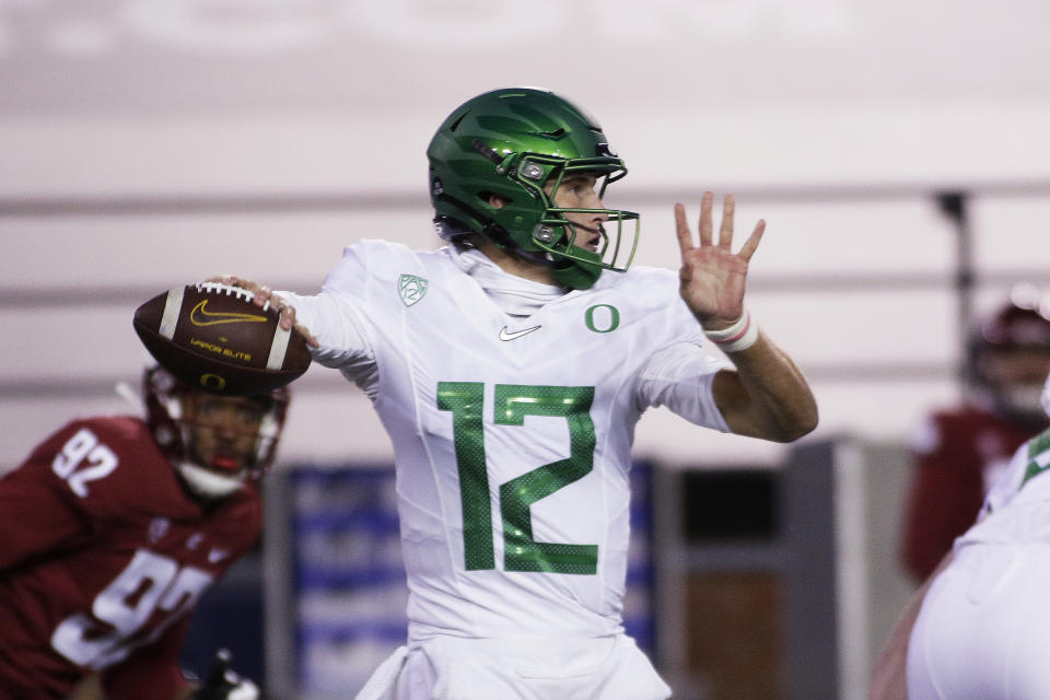 Oregon quarterback Tyler Shough (12) prepares to throw a pass during the first half of the team's NCAA college football game against Washington State in Pullman, Wash., Saturday, Nov. 14, 2020. (AP Photo/Young Kwak)