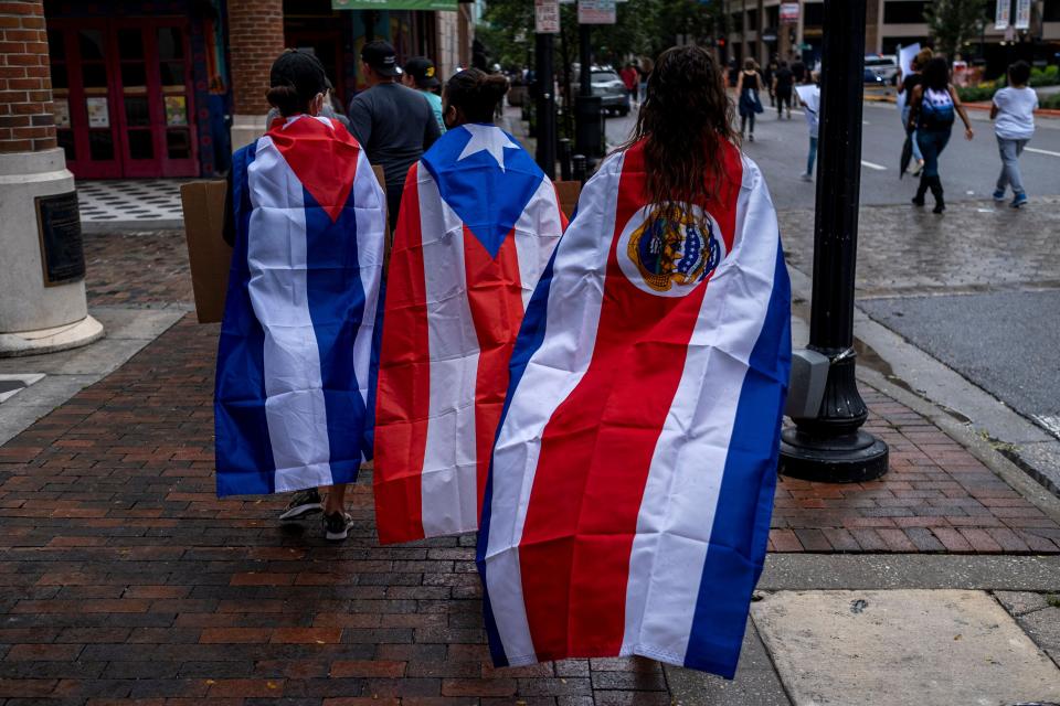 Protesters wear Cuban, Puerto Rican and Costa Rican flags during an anti-racist protest in Orlando, Florida, after the killing of George Floyd this spring. While Trump has accused Joe Biden of favoring radical "socialism" and fomenting unrest, the Biden campaign has begun to compare Trump's response to the protests to the authoritarian tendencies of the Latin American leaders the U.S. president claims to oppose. (Photo: RICARDO ARDUENGO via Getty Images)