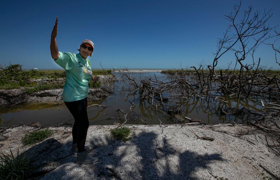 Holly D. Smith, former Mayor of Sanibel, describes the impact to the landscape along Gulfside City Park Beach on Monday, May 1, 2023, as storm surge from Hurricane Ian last year caused severe damage to access points and other areas along the coast.