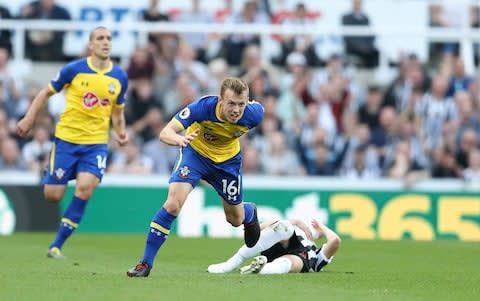  James Ward-Prowse of Southampton brings down Miguel Almiron of Newcastle United during the Premier League match between Newcastle United and Southampton  - Credit: GETTY IMAGES