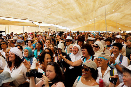 Palestinian and Israeli women celebrate inside a "peace tent" erected as part of an event organised by "Women Wage Peace" group calling for an end to the Israeli-Palestinian conflict, near the Jordan River, in the occupied West Bank October 8, 2017. REUTERS/Ronen Zvulun