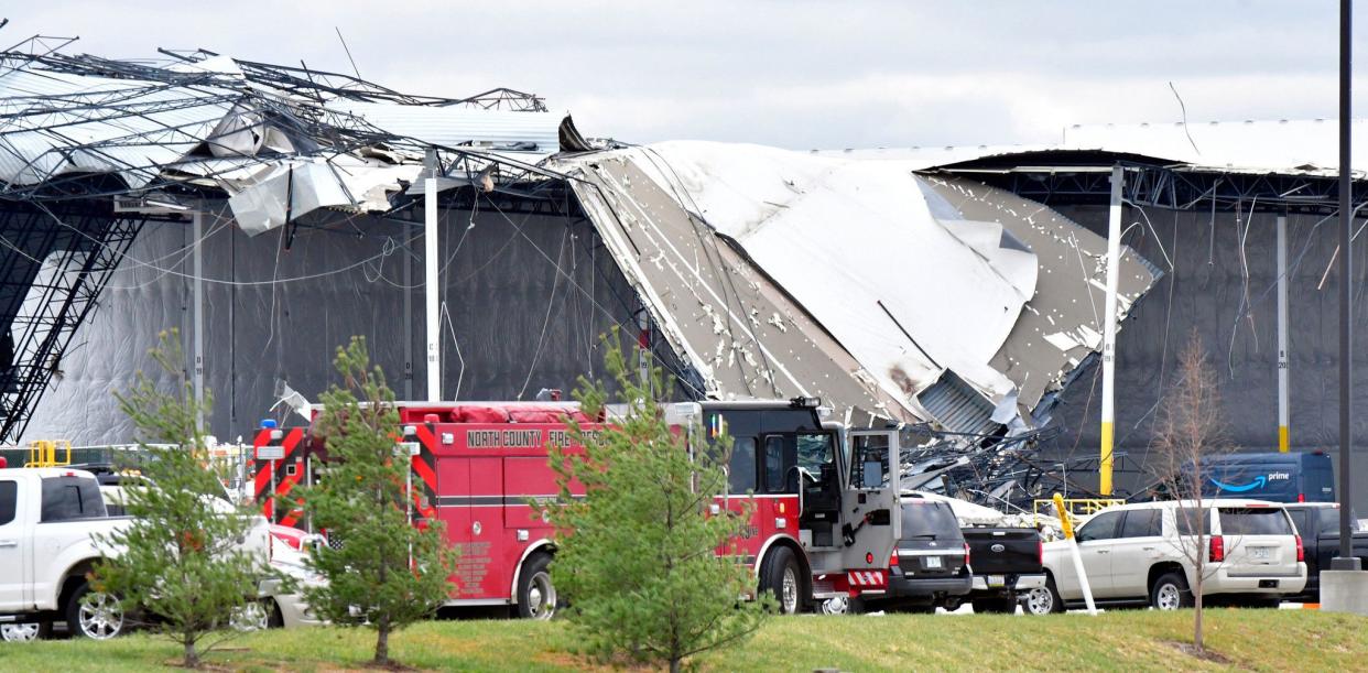 Workers remove debris from an Amazon Fulfillment Center in Edwardsville, Illinois, on December 11, 2021, after it was hit by a tornado. 