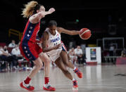 France's Valeriane Vukosavljevic (11) drives around United States' Breanna Stewart (10), left, during women's basketball preliminary round game at the 2020 Summer Olympics, Monday, Aug. 2, 2021, in Saitama, Japan. (AP Photo/Charlie Neibergall)