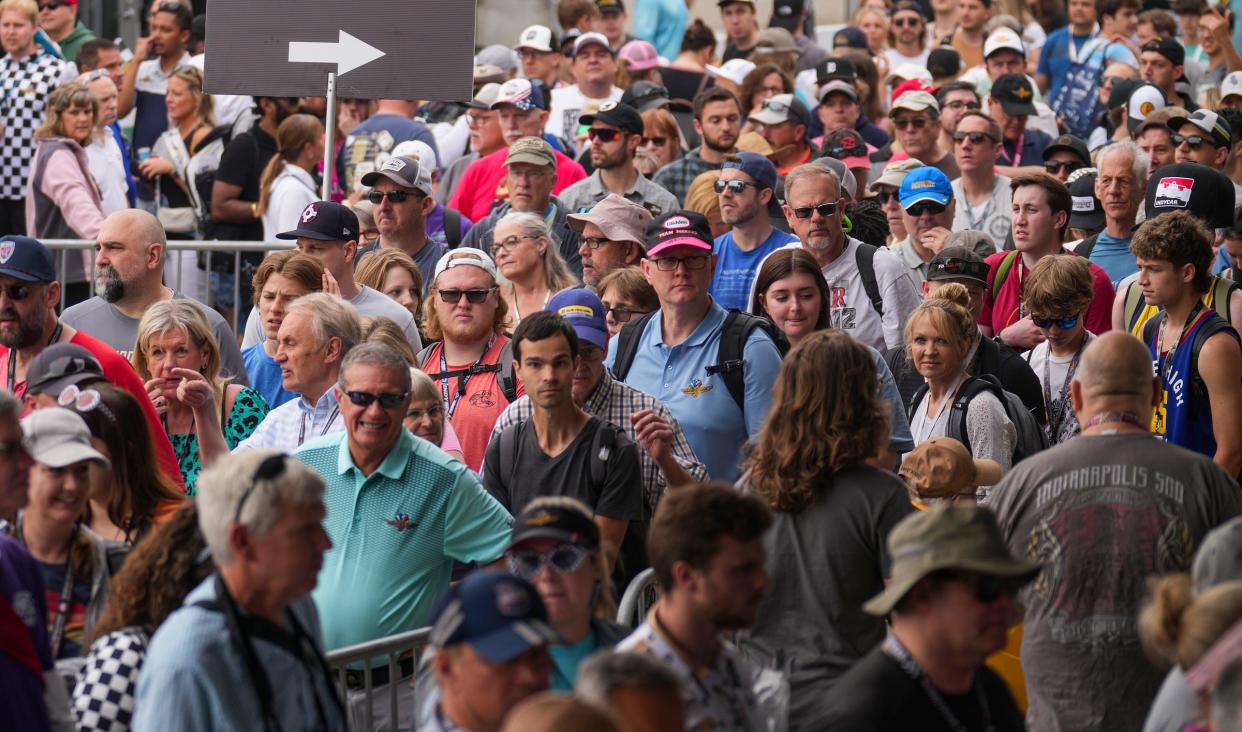 A dense crowd moves through the Gasoline Alley area Sunday, May 28, 2023, during the 107th running of the Indianapolis 500 at Indianapolis Motor Speedway. 