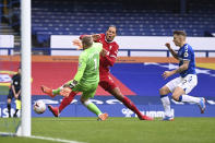 Liverpool's Virgil van Dijk, centre, is tackled and injured by Everton's goalkeeper Jordan Pickford, left, causing him to leave the match injured during the English Premier League soccer match between Everton and Liverpool at Goodison Park stadium, in Liverpool, England, Saturday, Oct. 17, 2020. (Laurence Griffiths/Pool via AP)