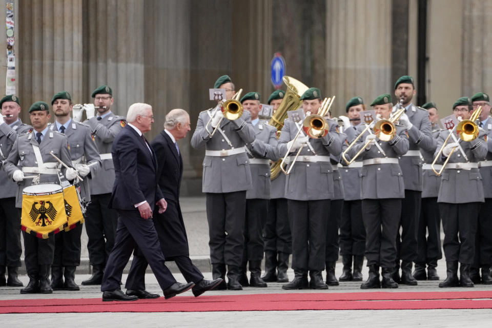 German President Frank-Walter Steinmeier, left, and Britain's King Charles III review troops during a welcome ceremony, in front of the Brandenburg Gate in Berlin, Wednesday, March 29, 2023. King Charles III arrived Wednesday for a three-day official visit to Germany. (AP Photo/Matthias Schrader)