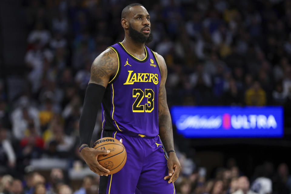 Los Angeles Lakers forward LeBron James (23) handles the ball during the second half of an NBA basketball game against the Minnesota Timberwolves Saturday, Dec. 30, 2023, in Minneapolis. (AP Photo/Matt Krohn)