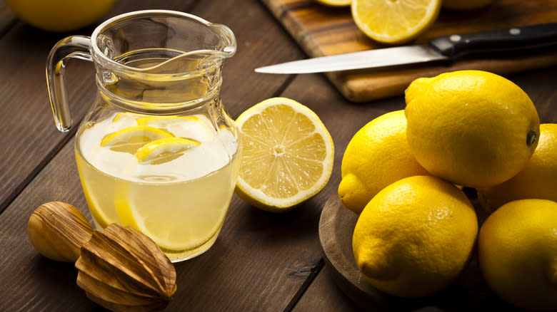 Lemons next to lemonade pitcher