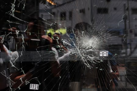 Broken glass is seen at the Legislative Council a day after protesters broke into the building, in Hong Kong