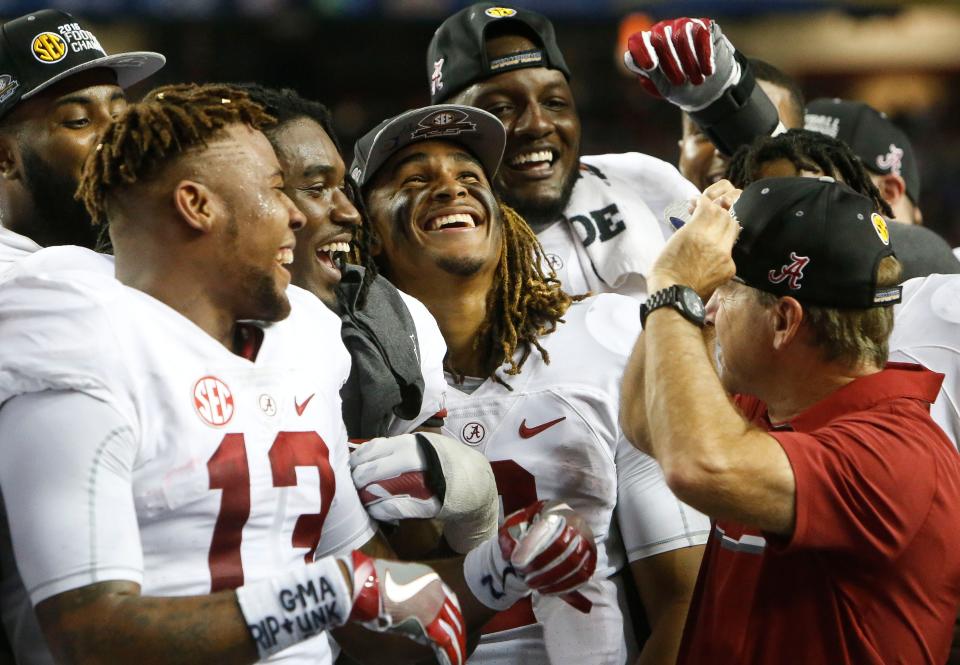 Alabama players ArDarius Stewart, Bo Scarbrough, Jalen Hurts and Cam Robinson laugh as Nick Saban adjusts the championship cap following the 54-16 SEC Championship win over Florida in the Georgia Dome Saturday, December 3, 2016.  Staff Photo/Gary Cosby Jr.