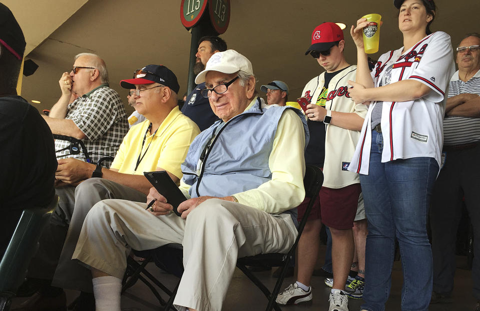 FILE - In this March 5, 2016, file photo, Tommy Giordano, special assistant to the general manager of the Atlanta Braves, scouts a spring training baseball game between the Braves and the Pittsburgh Pirates, in Kissimmee, Fla. “I'm going to do this until I die,” Giordano told me back in 2016, when I first met him at the Braves’ spring training complex, located within the confines of Disney World. “I can't wait to get up in the morning and go to the ballpark.” (AP Photo/Paul Newberry, File)