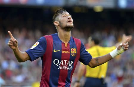 Barcelona's Neymar celebrates scoring a goal against Granada FC goalkeeper Roberto during their Spanish first division soccer match at Nou Camp stadium in Barcelona September 27, 2014. REUTERS/Gustau Nacarino