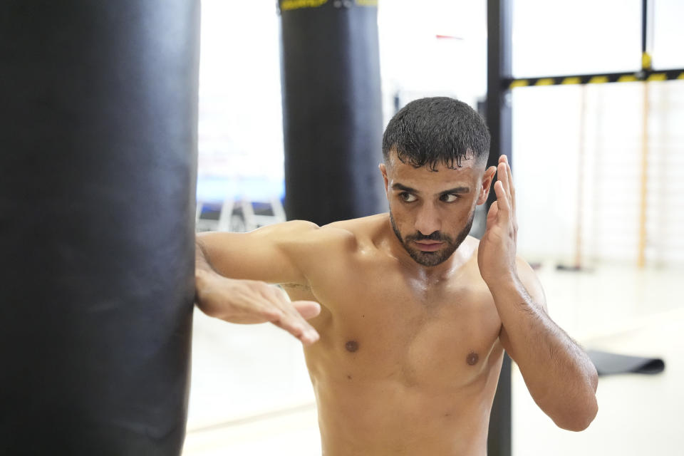 Olympic athlete in training using a punching bag